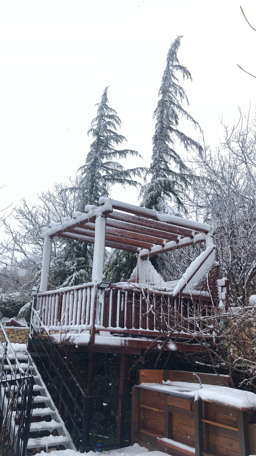 Snowy stairs and wooden deck at Al-Bayt